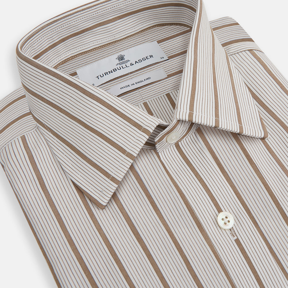 The Brown Multi Track Stripe Mayfair Shirt by Turnbull & Asser is a long-sleeved, collared, button-up in organic cotton with vertical brown and white stripes, classic fit, cuffs, and timeless style—shown on a plain white background.