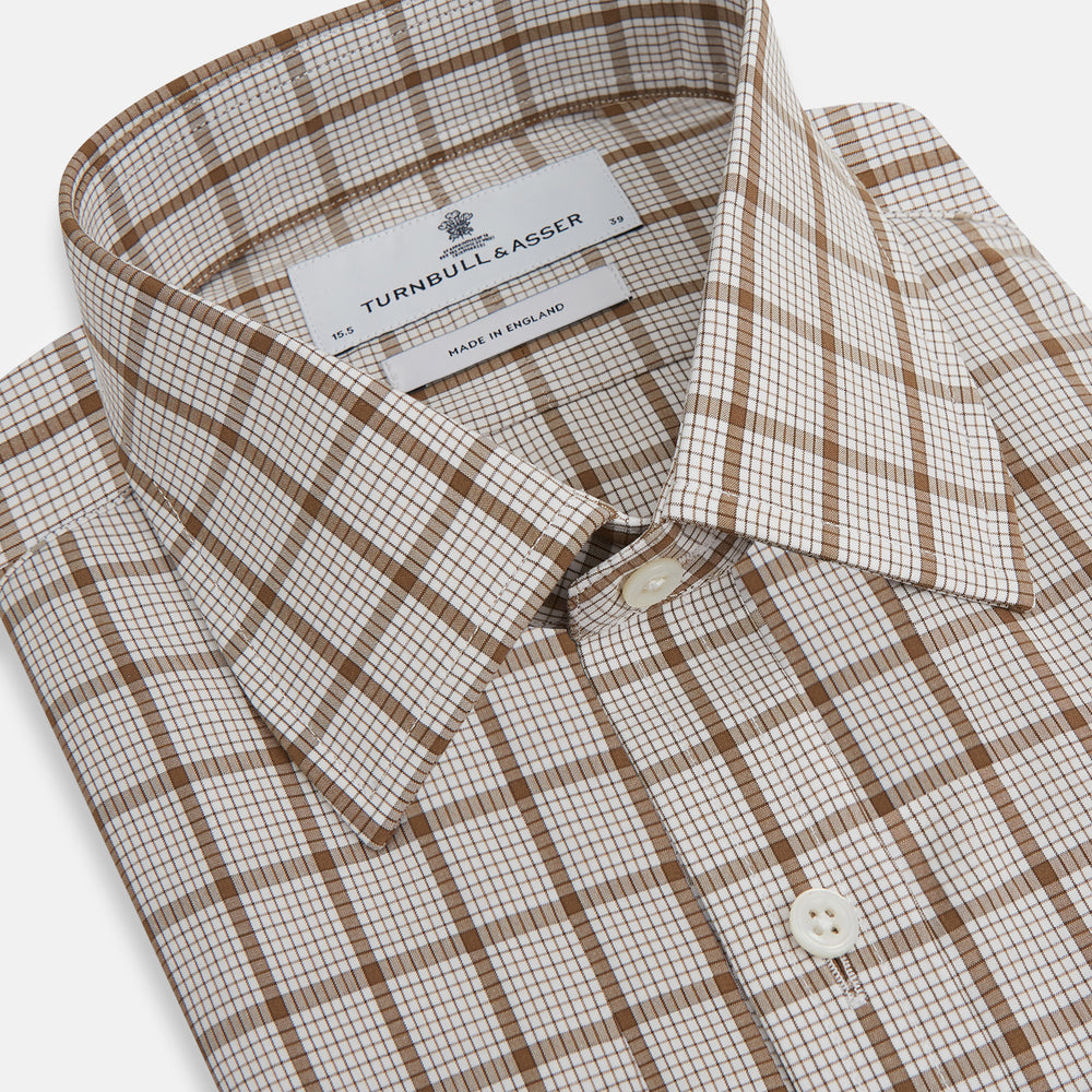 The Turnbull & Asser Brown Graph Overlay Check Mayfair Shirt, an organic cotton long-sleeve button-up with collar and cuffed sleeves, features a beige and white check pattern and is shown laid flat on a white background.