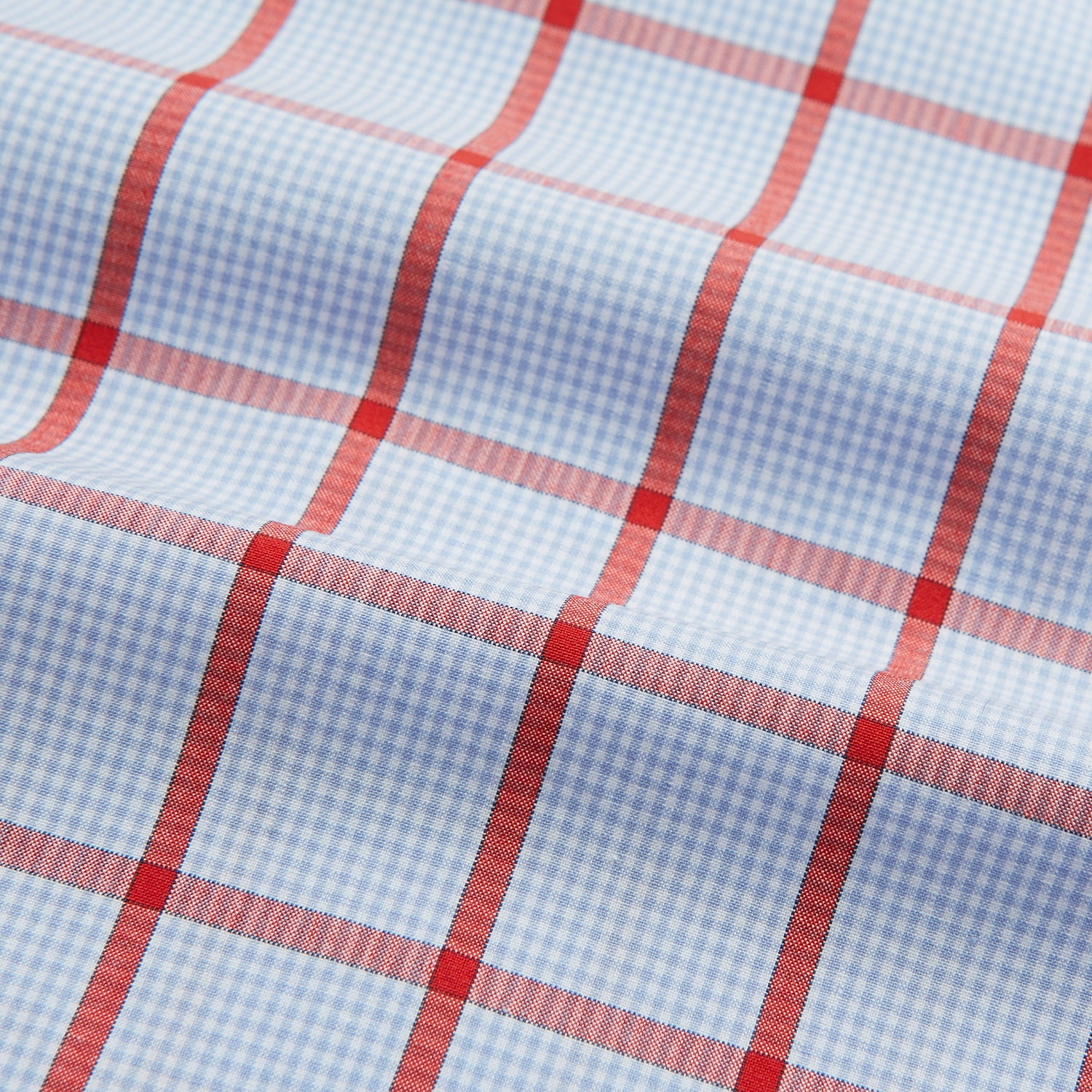 View 5 of product The Red Windowpane Check Mayfair Shirt by Turnbull & Asser is crafted from organic cotton in light blue with red and white windowpane checks, shown against a plain white background.
