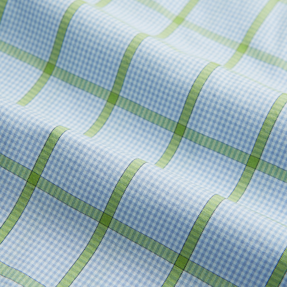 The Turnbull & Asser Light Green Windowpane Check Mayfair Shirt, crafted from organic cotton with a classic collar and buttoned cuffs, is displayed on a plain white background.