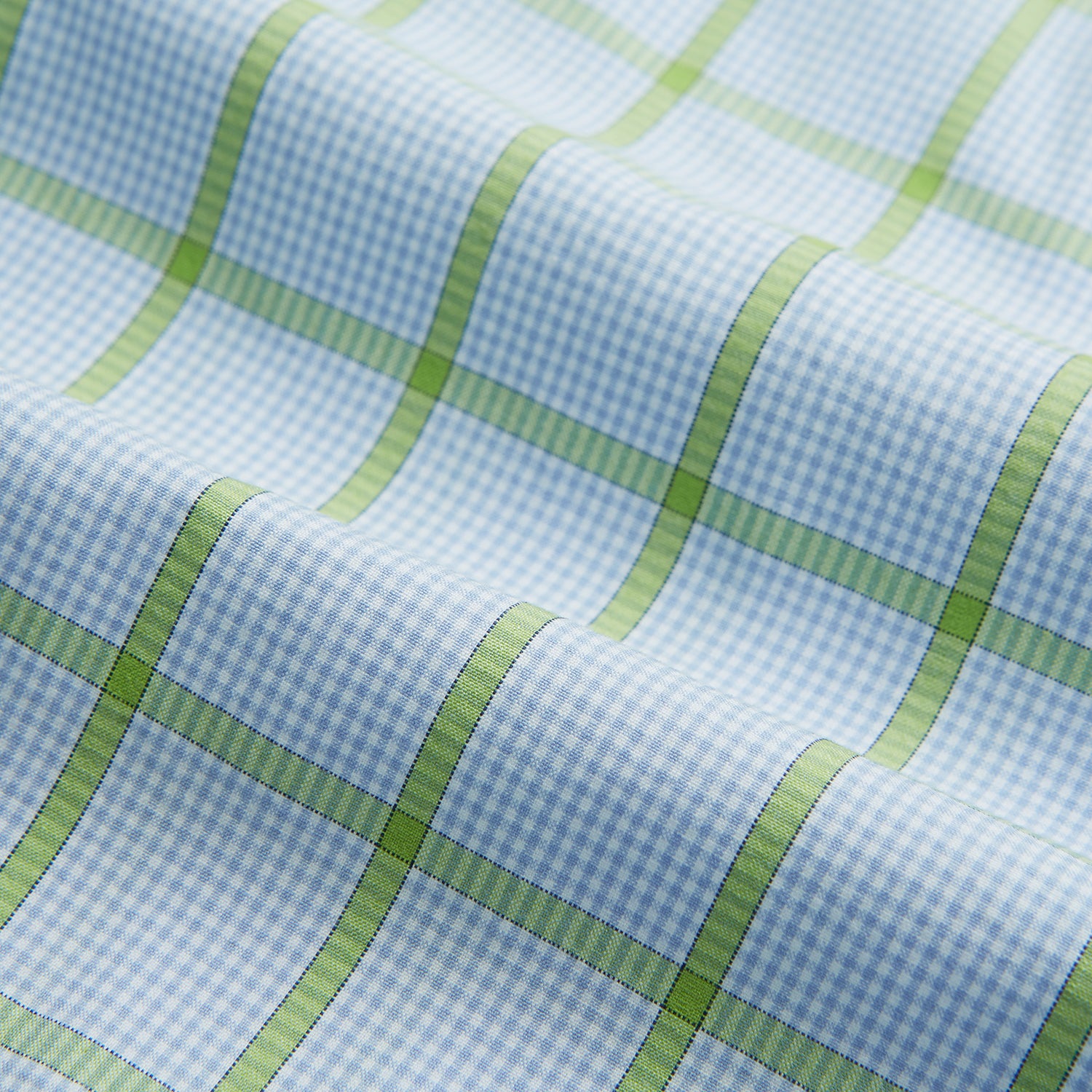 View 5 of product The Turnbull & Asser Light Green Windowpane Check Mayfair Shirt, crafted from organic cotton with a classic collar and buttoned cuffs, is displayed on a plain white background.