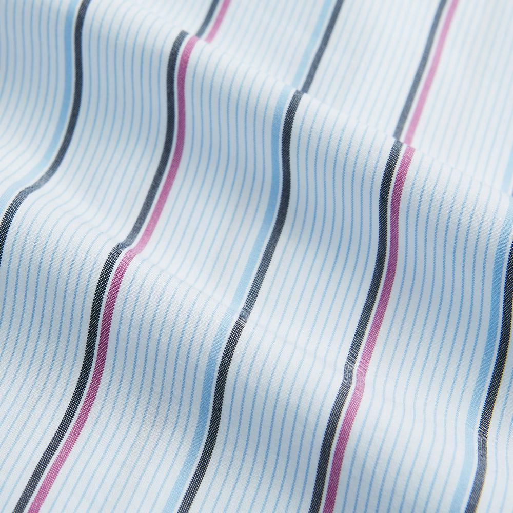 The Blue and Pink Shadow Stripe Mayfair Shirt by Turnbull & Asser features a T&A collar, long sleeves, buttoned cuffs, and a relaxed fit. Made from organic cotton with blue and pink shadow stripes for effortless style.