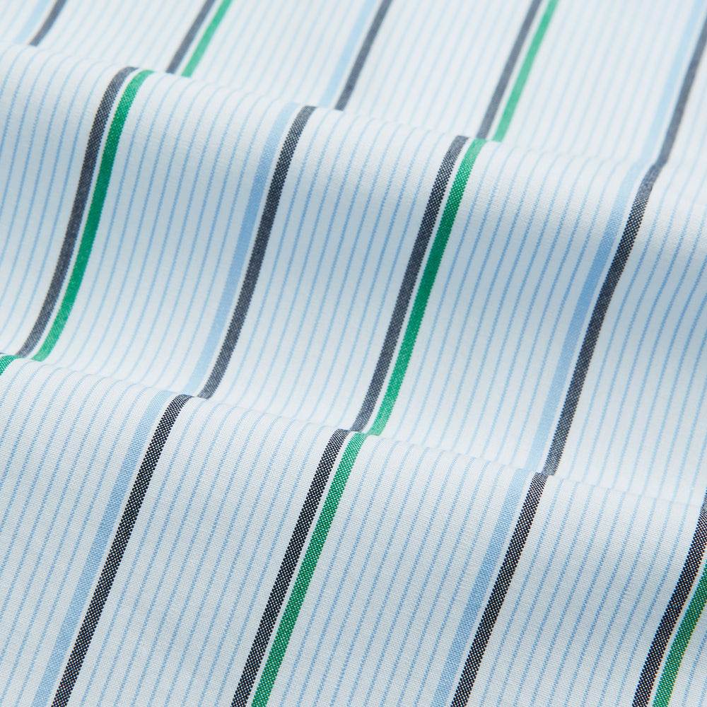 The Blue and Green Shadow Stripe Mayfair Shirt by Turnbull & Asser is a long-sleeved, organic cotton button-up with a T&A collar, buttoned cuffs, and blue and green vertical stripes on white. Features a slightly rounded hem.