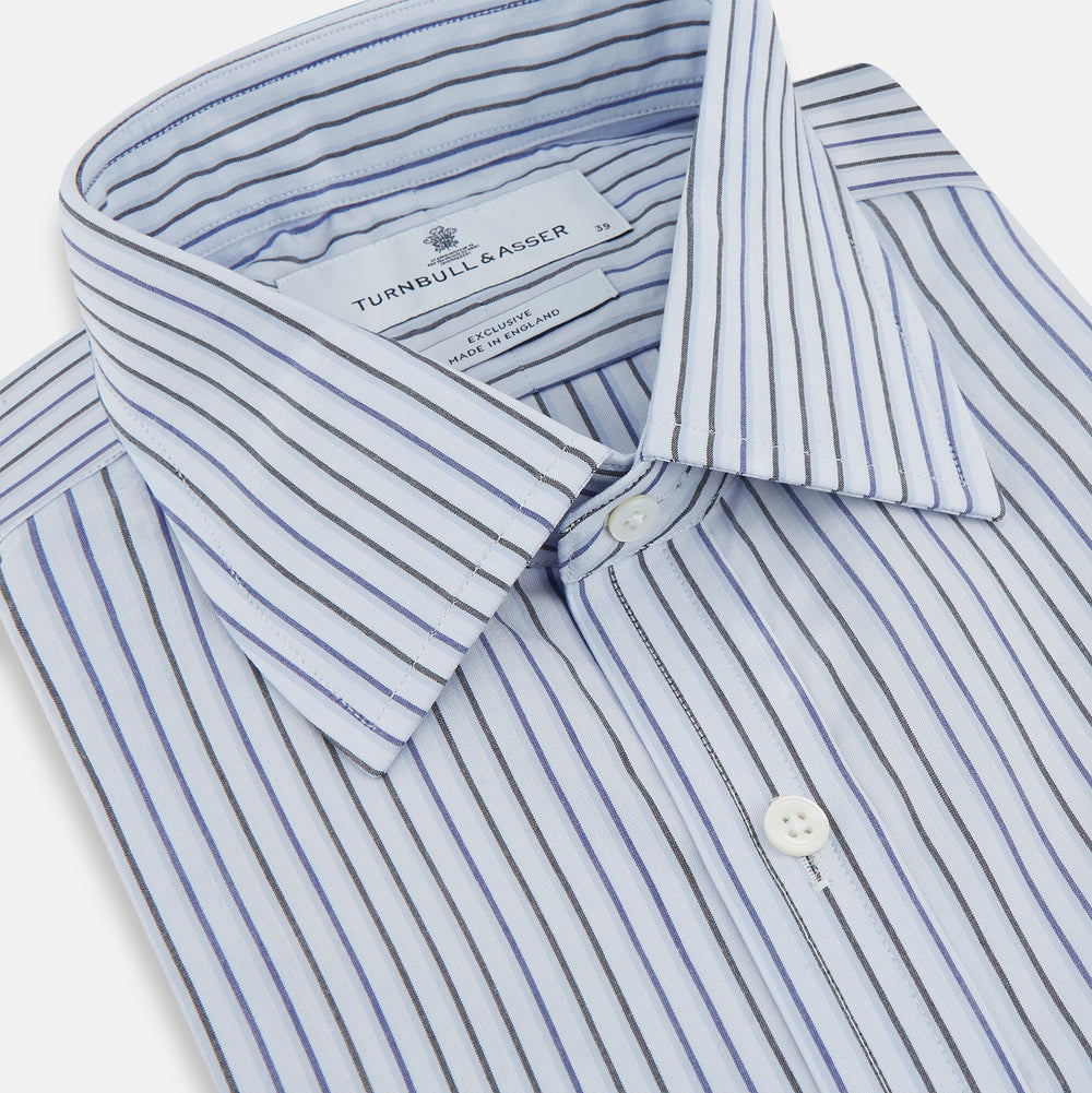 The Blue Shadow Pinstripe Mayfair Shirt by Turnbull & Asser is a long-sleeve, organic cotton dress shirt with light blue and white vertical stripes, a collar, and button-down front, shown against a white background.