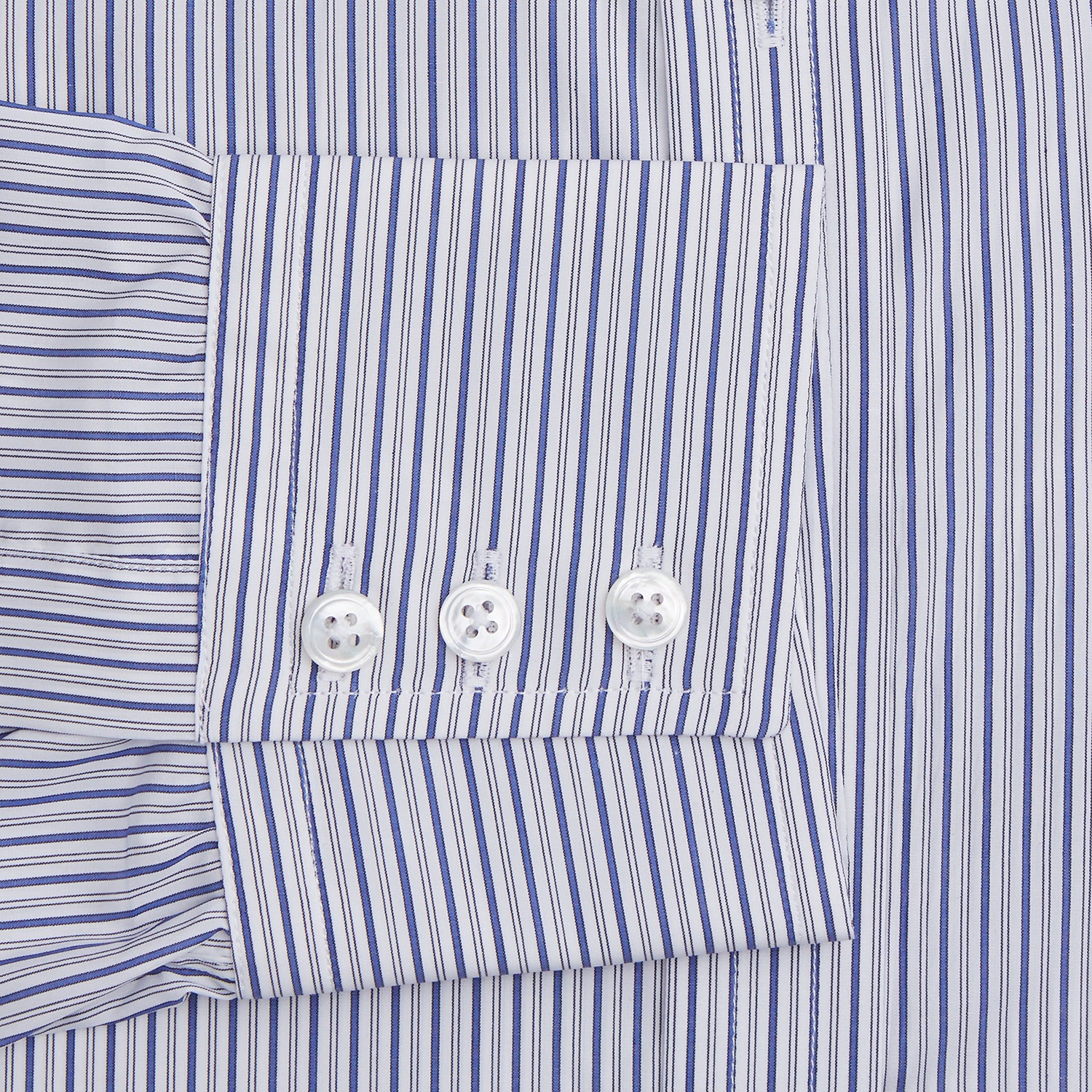 View 3 of product The Dark Blue Track Stripe Mayfair Shirt by Turnbull & Asser is a long-sleeve, button-up Egyptian cotton shirt with a classic collar and thin blue and white stripes, laid flat on a white background.