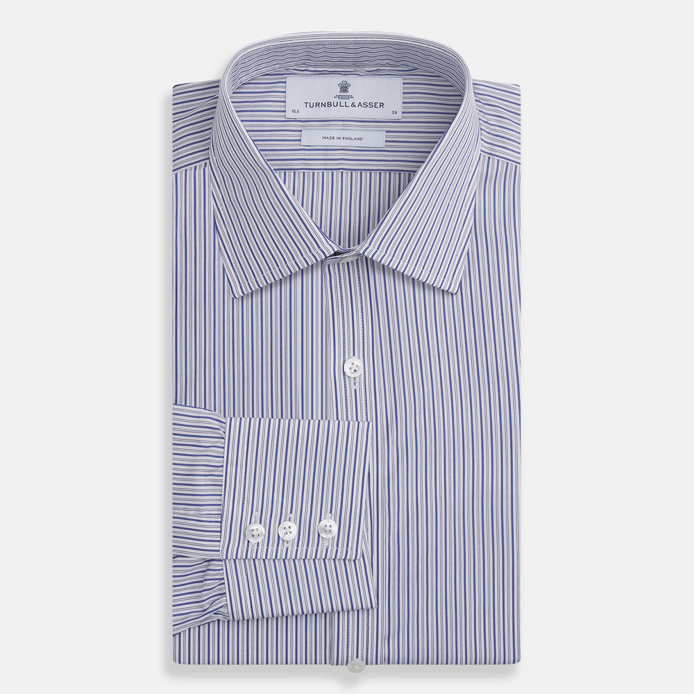 The Dark Blue Track Stripe Mayfair Shirt by Turnbull & Asser is a long-sleeve, button-up Egyptian cotton shirt with a classic collar and thin blue and white stripes, laid flat on a white background.