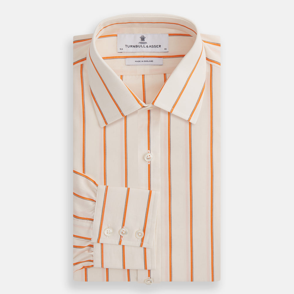 The Orange Track Stripe Mayfair Shirt by Turnbull & Asser features a white base with vertical orange stripes in breathable cotton, plus contrasting horizontal-striped collar and cuffs, shown neatly laid flat on a white background.