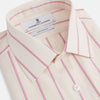 View 2 of product The Turnbull & Asser Pink Track Stripe Mayfair Shirt features long sleeves, a collar, and cream fabric with vertical pink stripes, crafted from breathable cotton and shown on a plain white background.