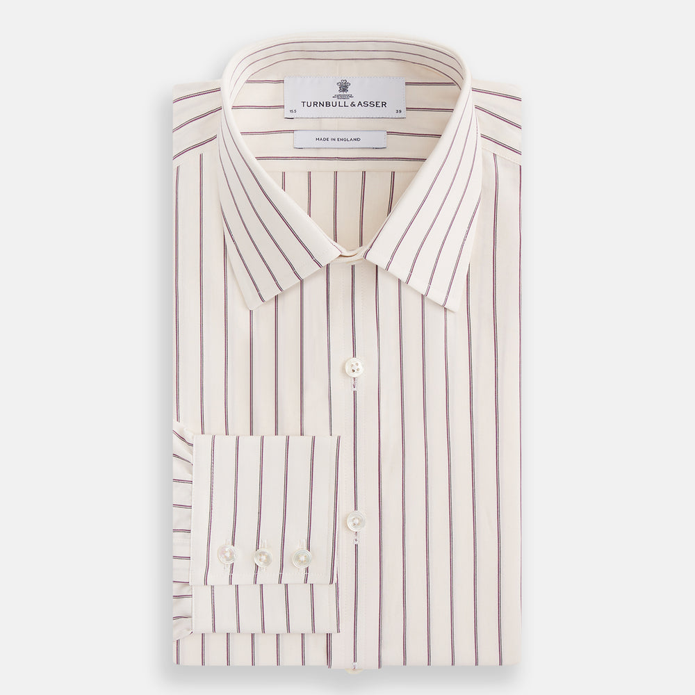 The Purple Halo Stripe Mayfair Shirt by Turnbull & Asser is an organic cotton, long-sleeved shirt with a T&A collar, buttoned cuffs, and thin black stripes on a white base, neatly laid flat on a white background.