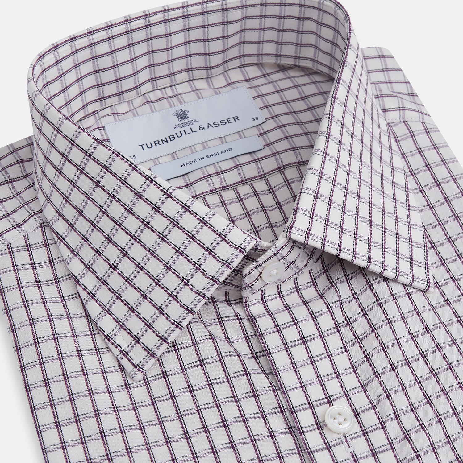 View 2 of product The Turnbull & Asser Purple Tattersall Check Mayfair Shirt is a long-sleeved, organic cotton button-up with a pointed collar and buttoned cuffs, shown flat on a white background.