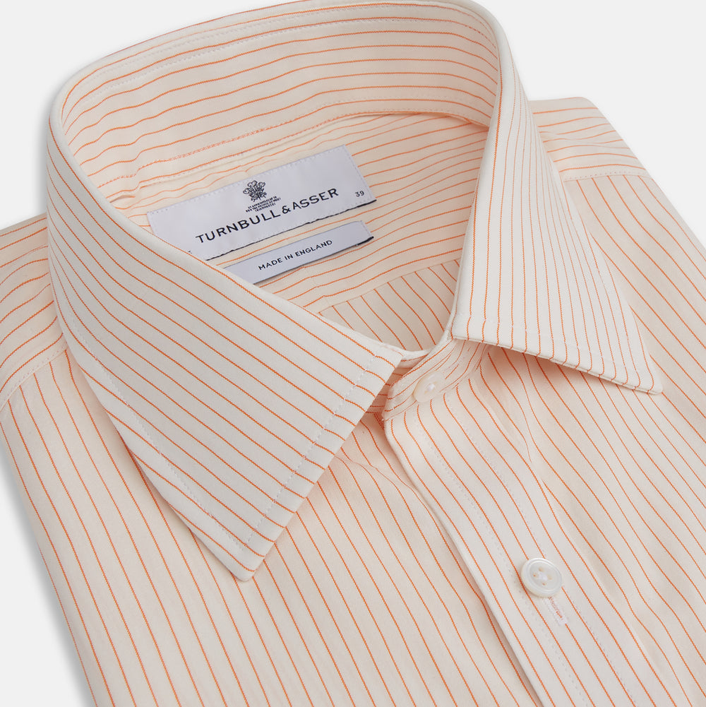 The Turnbull & Asser Orange Pinstripe Mayfair Shirt with a T&A collar and thin peach and white stripes is laid flat on a white background.
