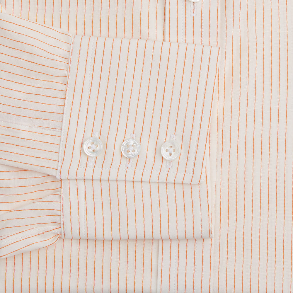 The Turnbull & Asser Orange Pinstripe Mayfair Shirt with a T&A collar and thin peach and white stripes is laid flat on a white background.
