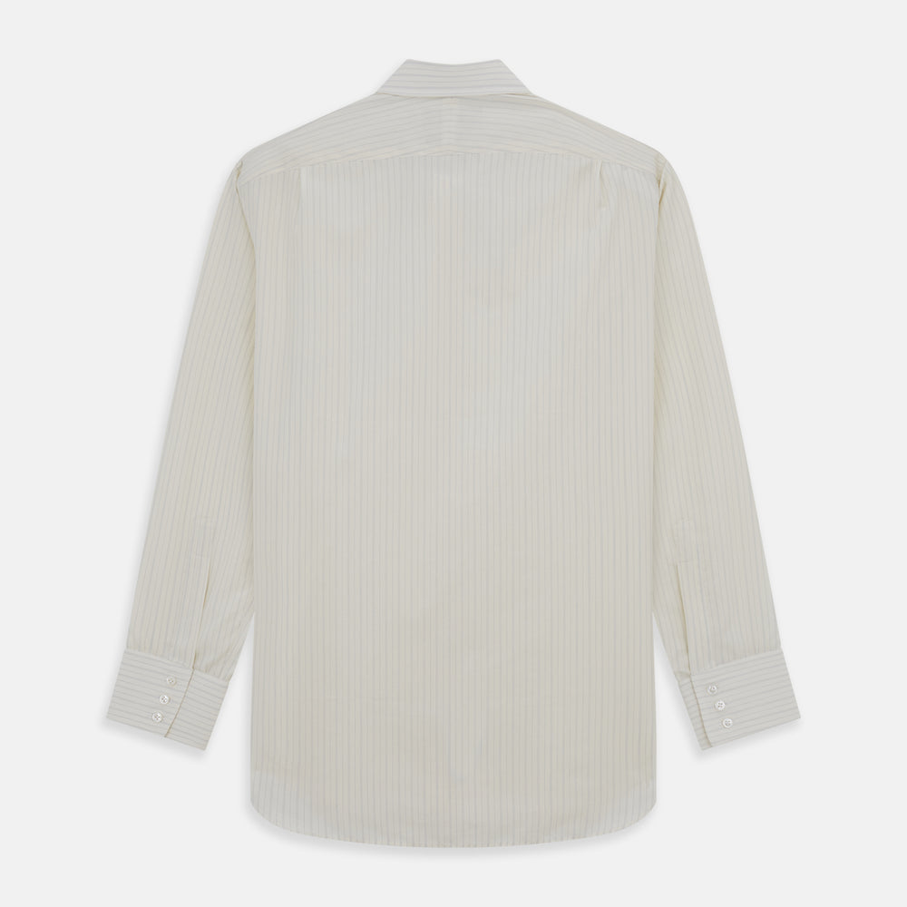 The Turnbull & Asser Pale Blue Fine Track Stripe Mayfair Shirt is a long-sleeve, cream-colored organic cotton shirt with subtle pale blue stripes, a T&A collar, and buttoned cuffs, shown on a plain white background.