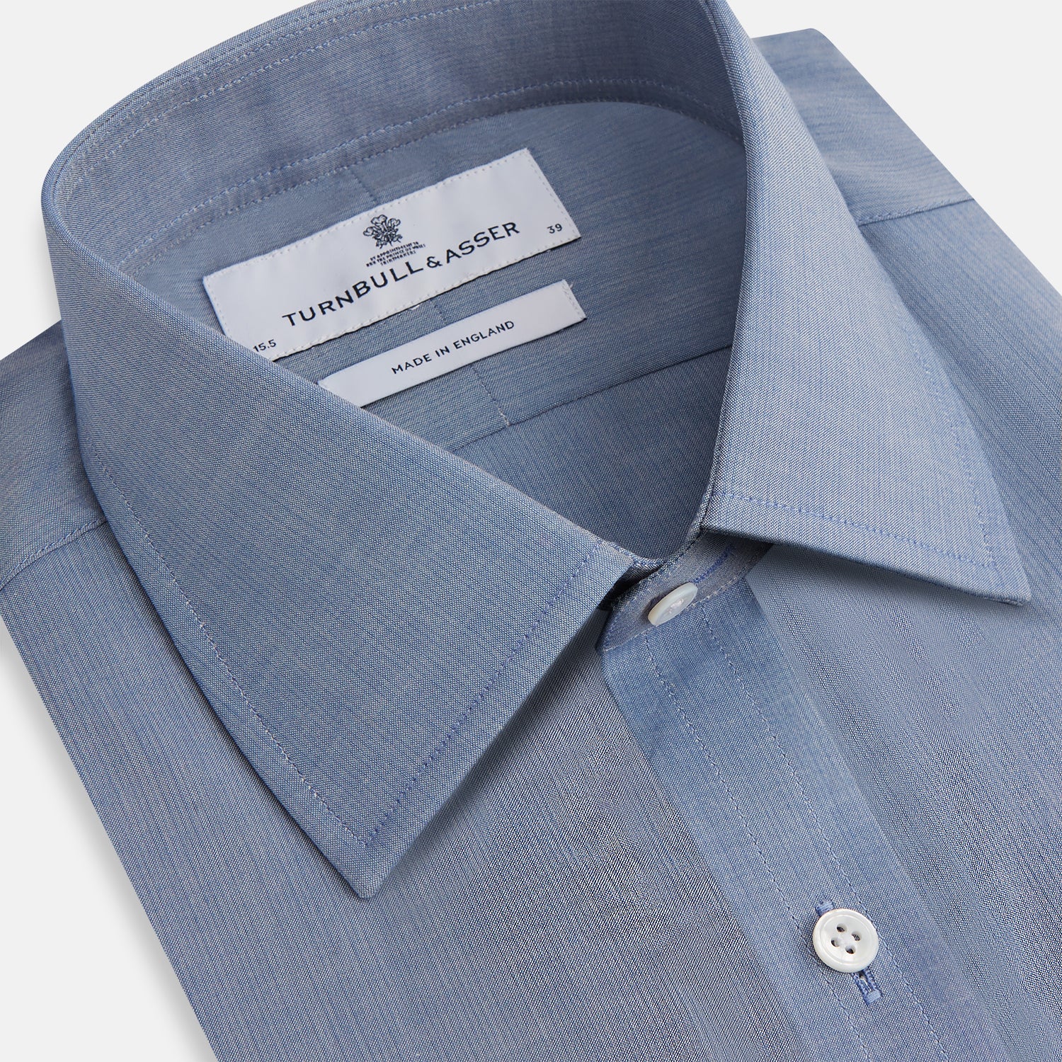 View 2 of product The Blue Mayfair Shirt by Turnbull & Asser is a long-sleeve, textured blue shirt with a classic T&A collar and white buttons, crafted from organic cotton and shown against a plain white background.