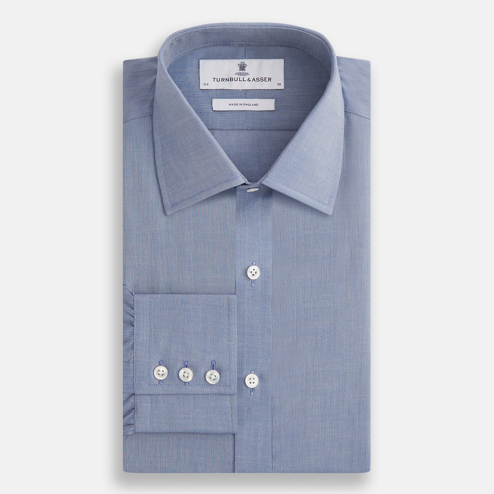 The Blue Mayfair Shirt by Turnbull & Asser is a long-sleeve, textured blue shirt with a classic T&A collar and white buttons, crafted from organic cotton and shown against a plain white background.