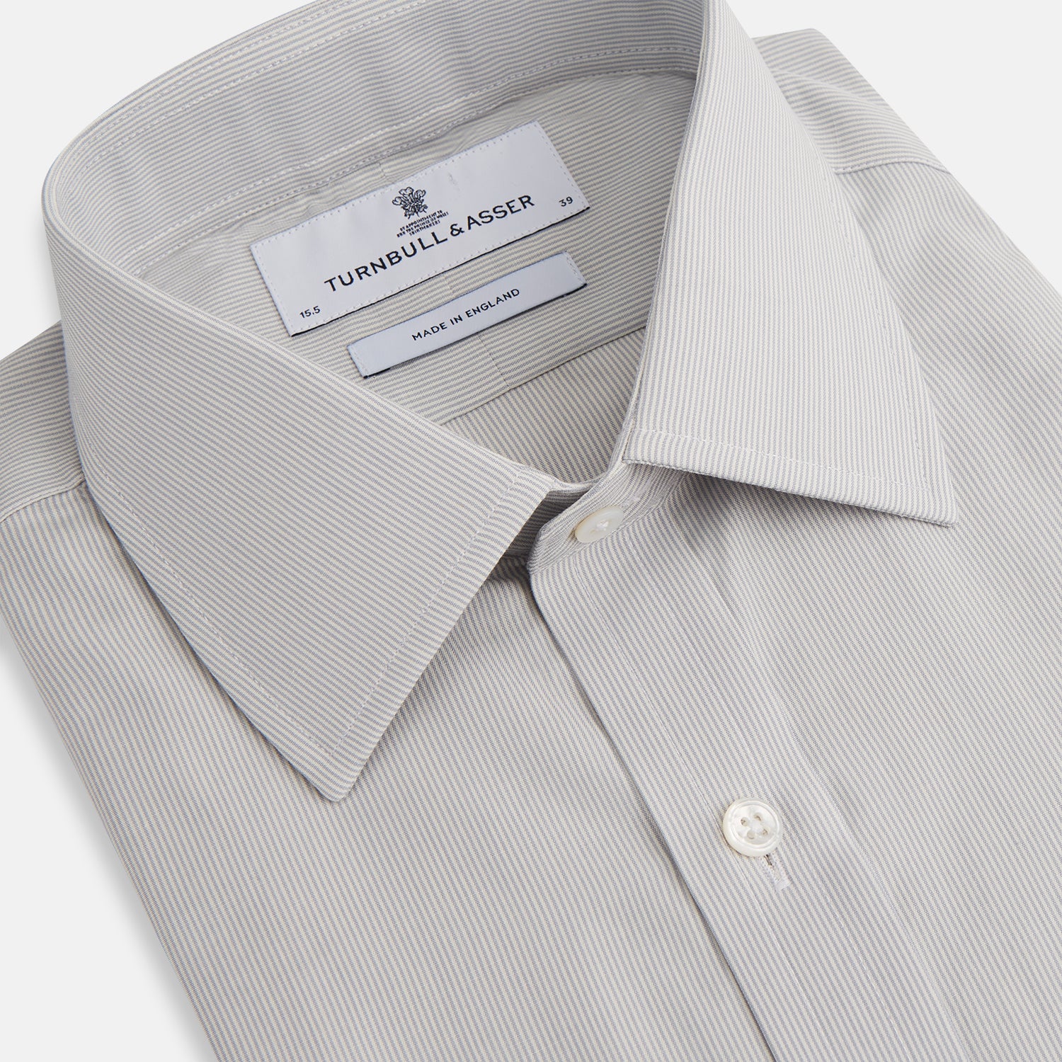 View 2 of product The Turnbull & Asser Pale Blue Fine Stripe Mayfair Shirt features a classic collar, white buttons, cuffs, a slightly curved hem, and subtle pale blue stripes for a formal tailored look. Displayed on a plain white background.