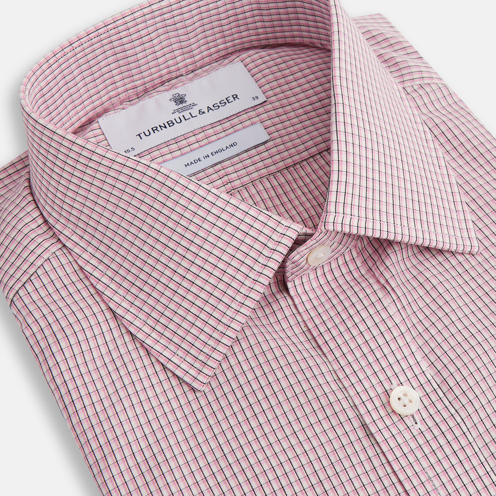 The Turnbull & Asser Pink Fine Graph Check Mayfair Shirt features long sleeves, breathable cotton, a pointed collar, 3-button cuffs, white buttons, and a red and white check pattern—shown on a plain white background.