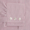 View 3 of product The Turnbull & Asser Pink Fine Graph Check Mayfair Shirt features long sleeves, breathable cotton, a pointed collar, 3-button cuffs, white buttons, and a red and white check pattern—shown on a plain white background.