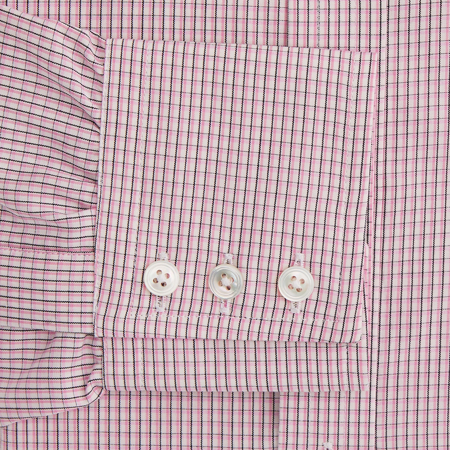 View 3 of product The Turnbull & Asser Pink Fine Graph Check Mayfair Shirt features long sleeves, breathable cotton, a pointed collar, 3-button cuffs, white buttons, and a red and white check pattern—shown on a plain white background.