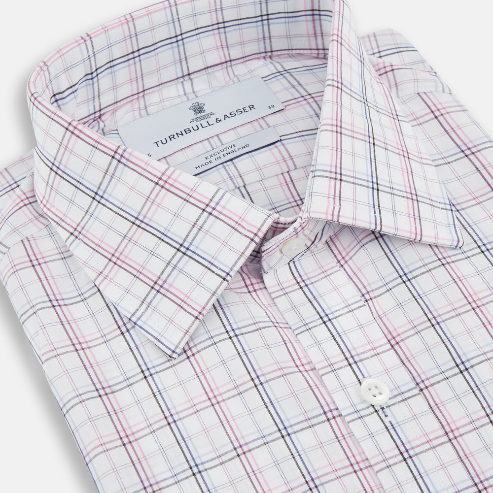 The Purple and Blue Multi Check Mayfair Shirt by Turnbull & Asser is a long-sleeved, organic cotton button-down with a classic T&A collar, featuring a white base with blue, purple, and pink checks, displayed on a white background.