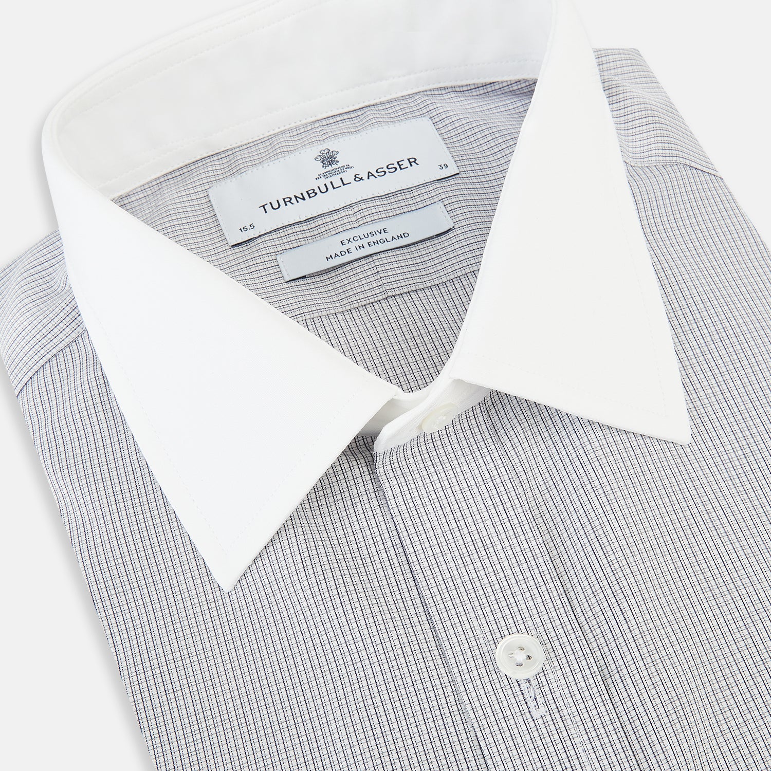 View 2 of product A Chequered White on Navy Regular Fit Shirt in Cotton by Turnbull & Asser UK, featuring a light gray finely checked pattern with a contrasting white collar and white French cuffs, long sleeves, buttoned up and displayed against a white background.