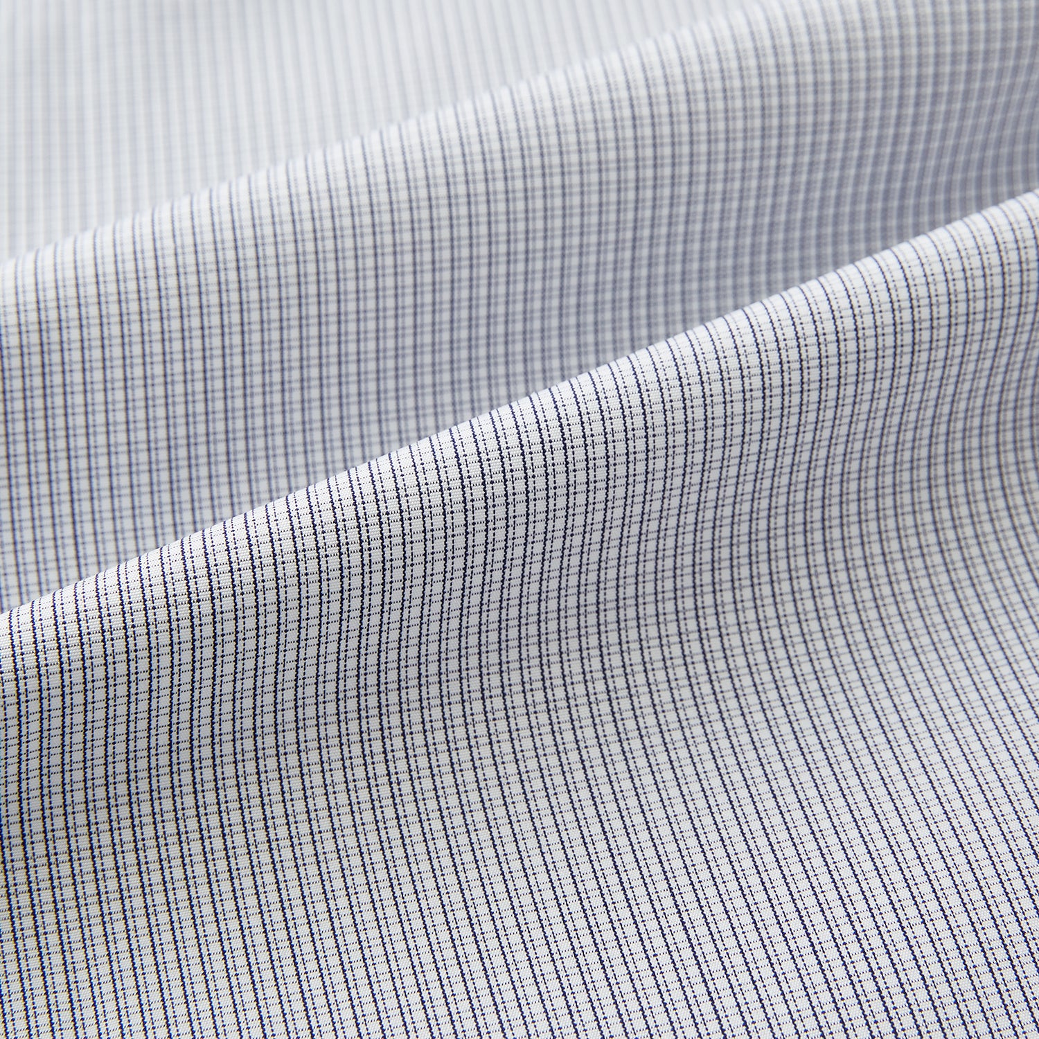 View 6 of product A Chequered White on Navy Regular Fit Shirt in Cotton by Turnbull & Asser UK, featuring a light gray finely checked pattern with a contrasting white collar and white French cuffs, long sleeves, buttoned up and displayed against a white background.