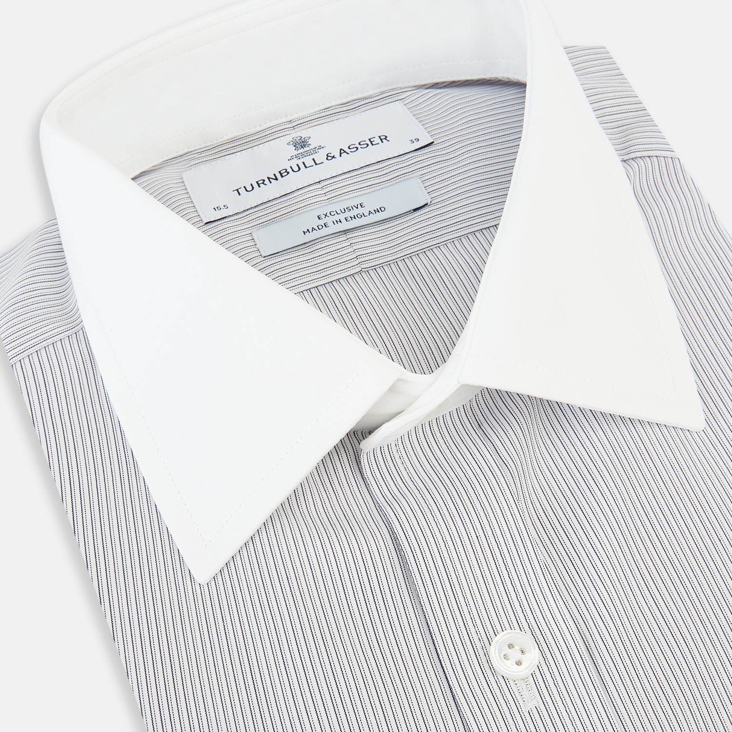 View 2 of product A navy men’s dress shirt with subtle white stripes, crafted from cotton and laid flat on a plain white background; the Striped White on Navy Regular Fit Shirt by Turnbull & Asser UK is a timeless formal piece for any wardrobe.