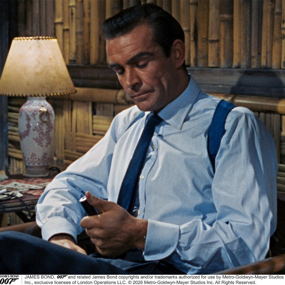 The Turnbull & Asser Dr. No Blue Cotton Shirt with cocktail cuffs, inspired by James Bond, features a classic collar and white buttons, displayed on a plain white background.
