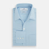 View 4 of product The Blue Cotton Cashmere Chelsea Shirt by Turnbull & Asser, a light blue long-sleeve button-up with a chest pocket, crafted from soft cotton and cashmere, is shown laid flat on a white background.