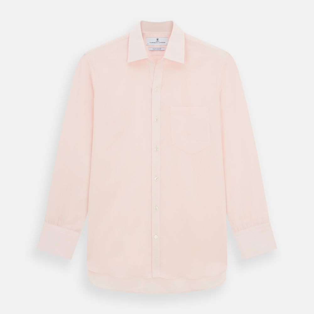 The Turnbull & Asser Pale Pink Cotton Cashmere Chelsea Shirt features long sleeves, a chest pocket, spread collar, and buttoned cuffs. Crafted from a luxurious cotton-cashmere blend, it's shown laid flat on a white background.