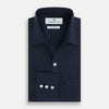 View 4 of product The Turnbull & Asser Navy Cotton Cashmere Chelsea Shirt features long sleeves, a classic collar, front chest pocket, and white buttons, shown laid flat on a white background.