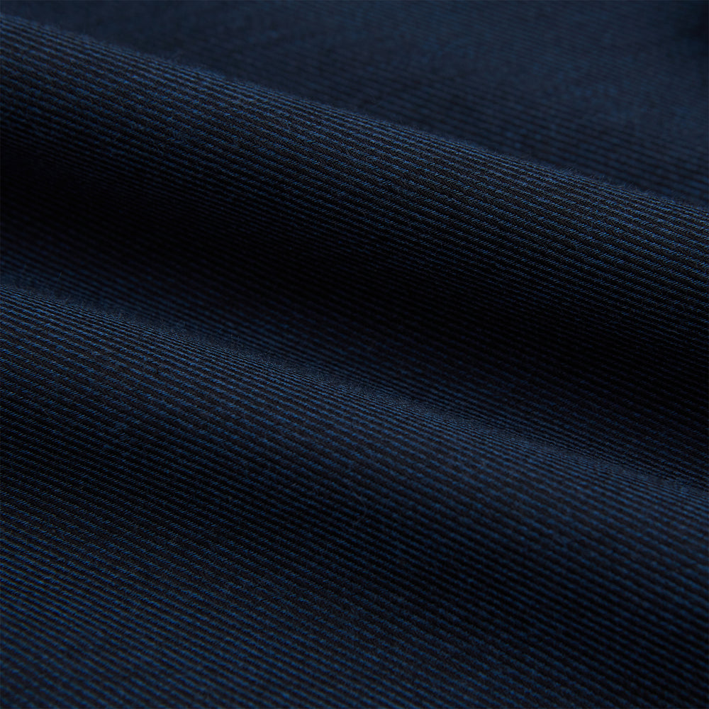 The Turnbull & Asser Navy Cotton Cashmere Chelsea Shirt features long sleeves, a classic collar, front chest pocket, and white buttons, shown laid flat on a white background.