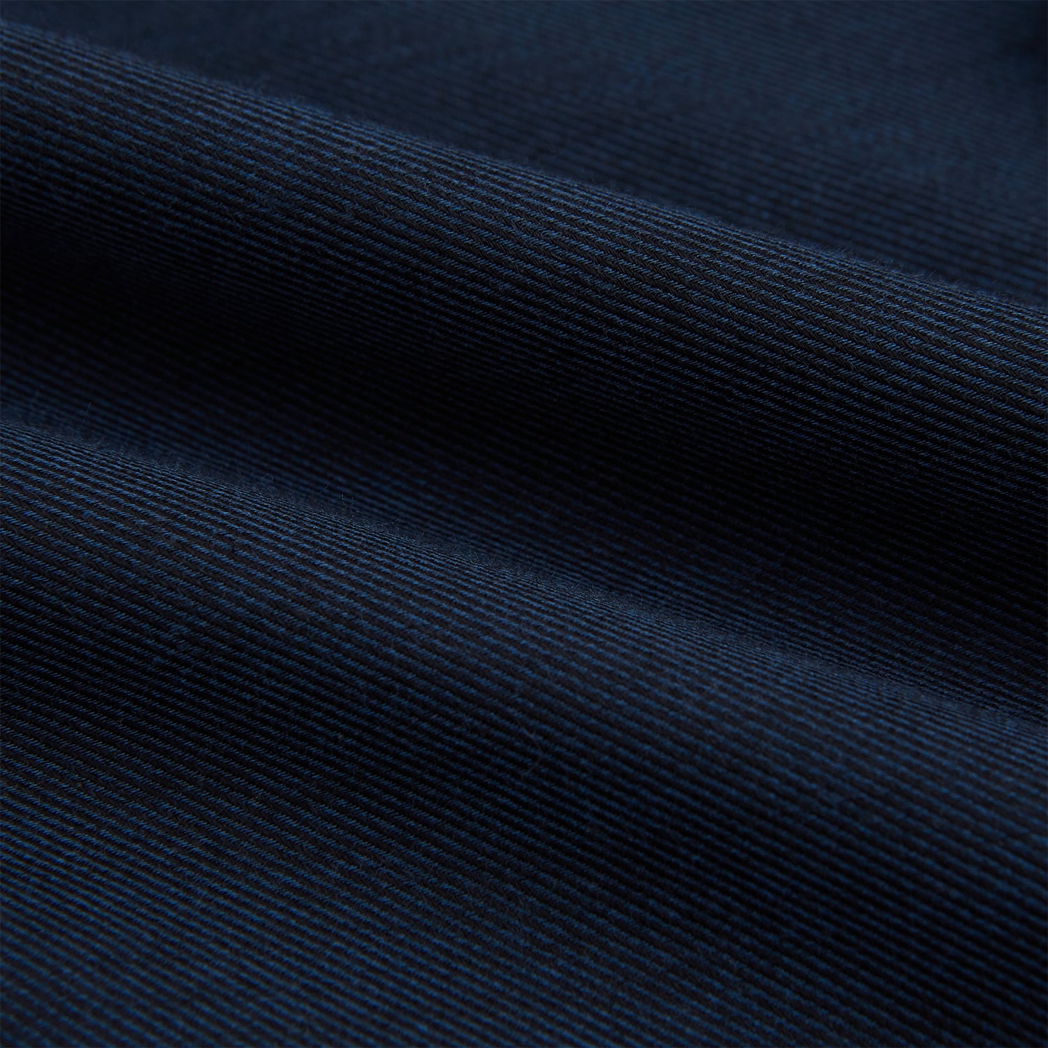 View 6 of product The Turnbull & Asser Navy Cotton Cashmere Chelsea Shirt features long sleeves, a classic collar, front chest pocket, and white buttons, shown laid flat on a white background.