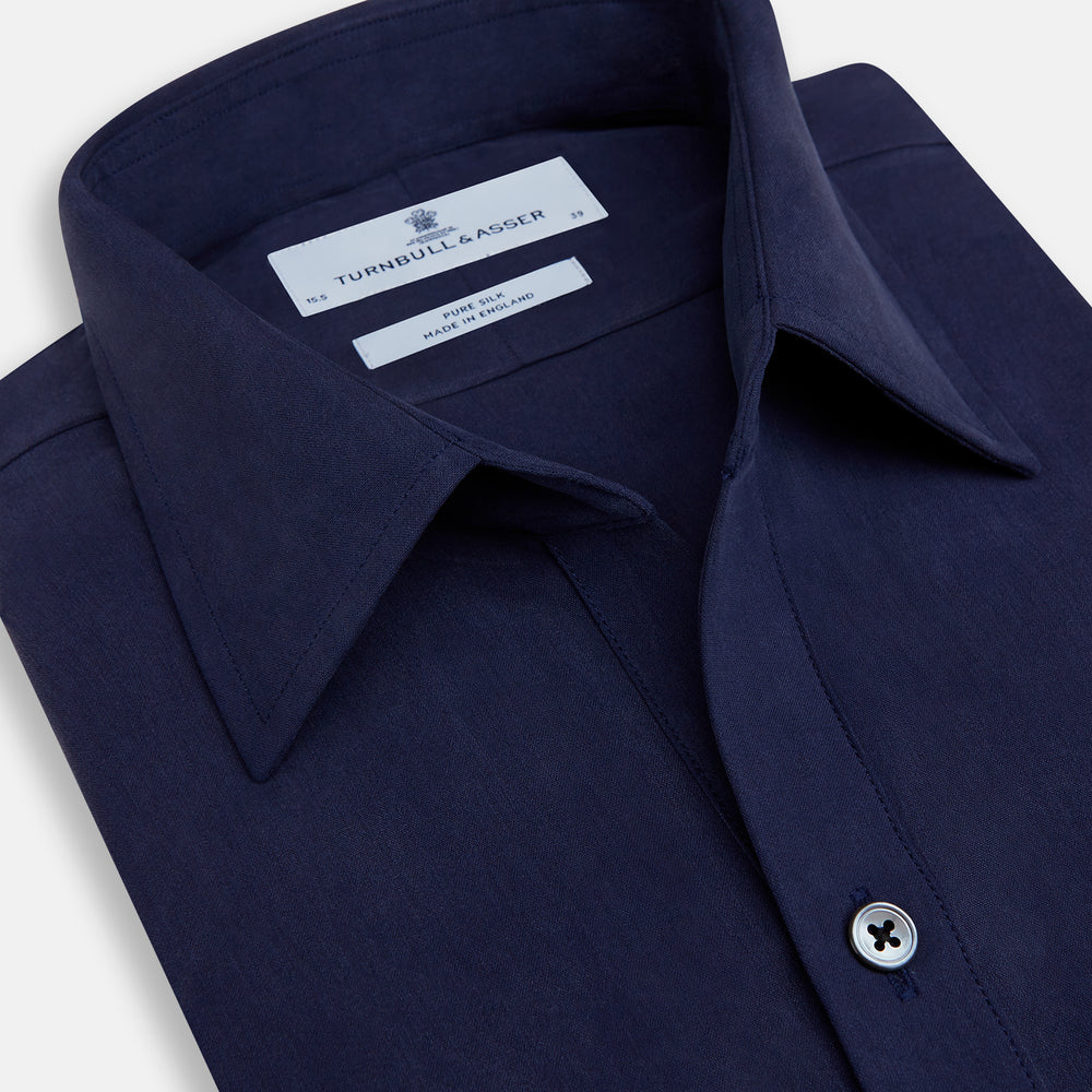 The Navy Silk Chelsea Shirt by Turnbull & Asser features a long sleeve, collar, single chest pocket, and a refined Chelsea fit, displayed against a white background.