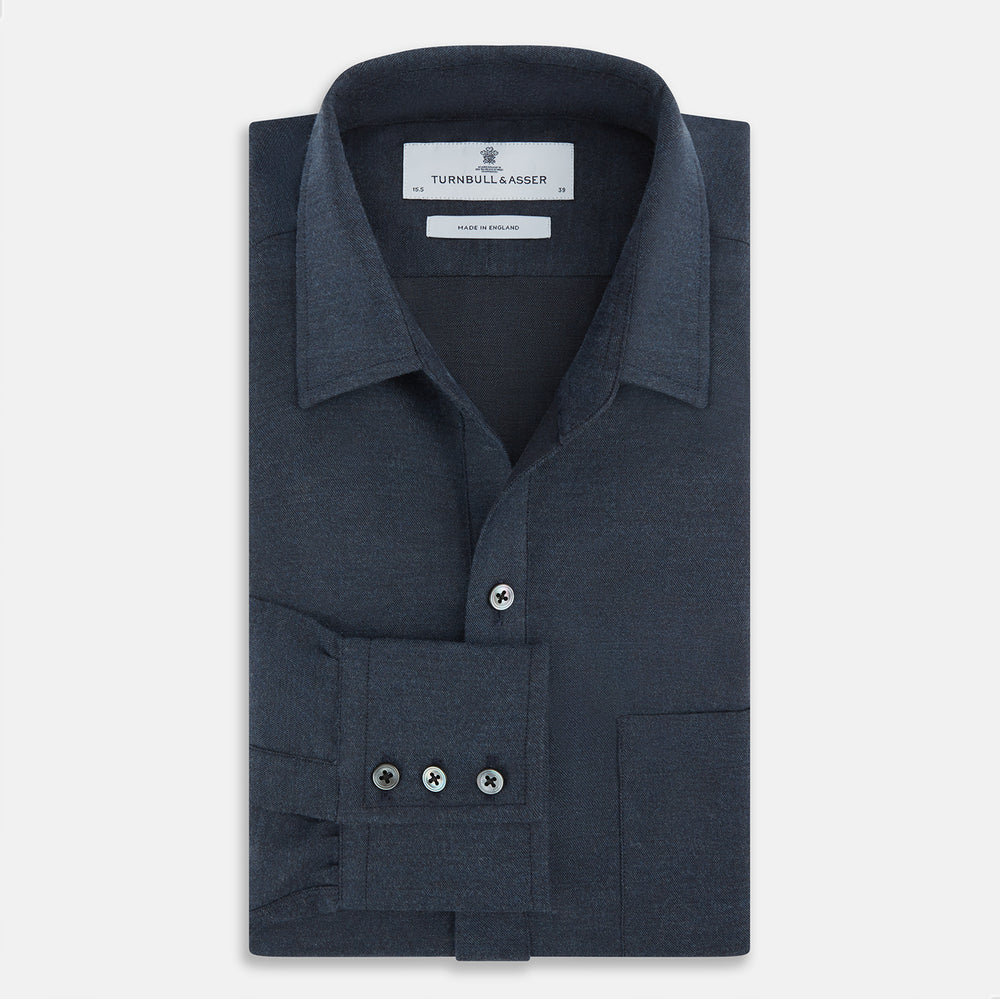 The Navy Chelsea Shirt by Turnbull & Asser is a long-sleeve, button-down flannel with a chest pocket, shown flat on a white background for a classic smart-casual style.