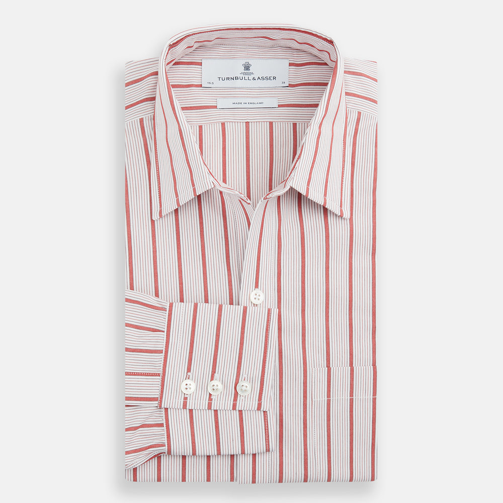 The Turnbull & Asser Red Multi Track Stripe Chelsea Shirt features a classic open collar, long sleeves, red vertical stripes on white, and a left chest pocket—laid flat against a plain background.