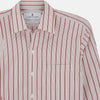 View 4 of product The Turnbull & Asser Red Multi Track Stripe Chelsea Shirt features a classic open collar, long sleeves, red vertical stripes on white, and a left chest pocket—laid flat against a plain background.