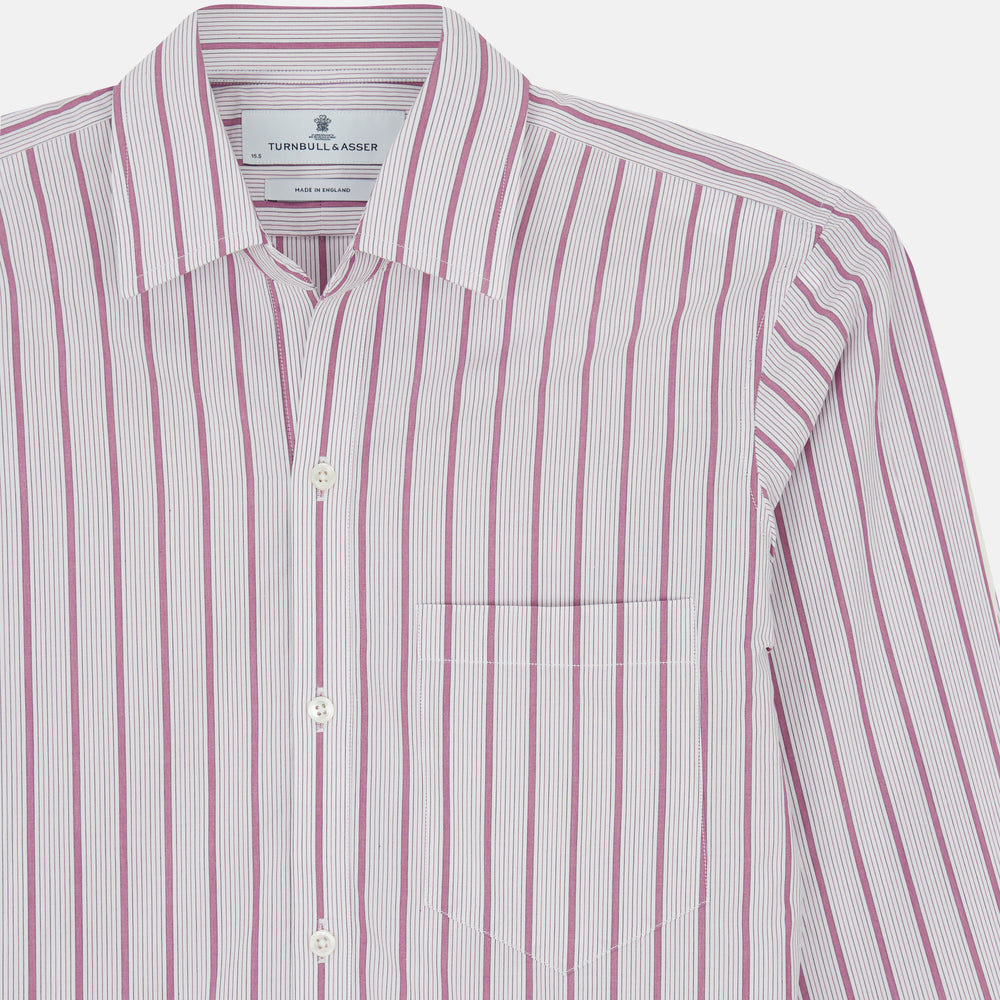 The Purple Multi Track Stripe Chelsea Shirt by Turnbull & Asser features a long-sleeve button-up design with an open Chelsea collar, purple background, vertical multi track stripes, front left pocket, and classic buttoned cuffs.