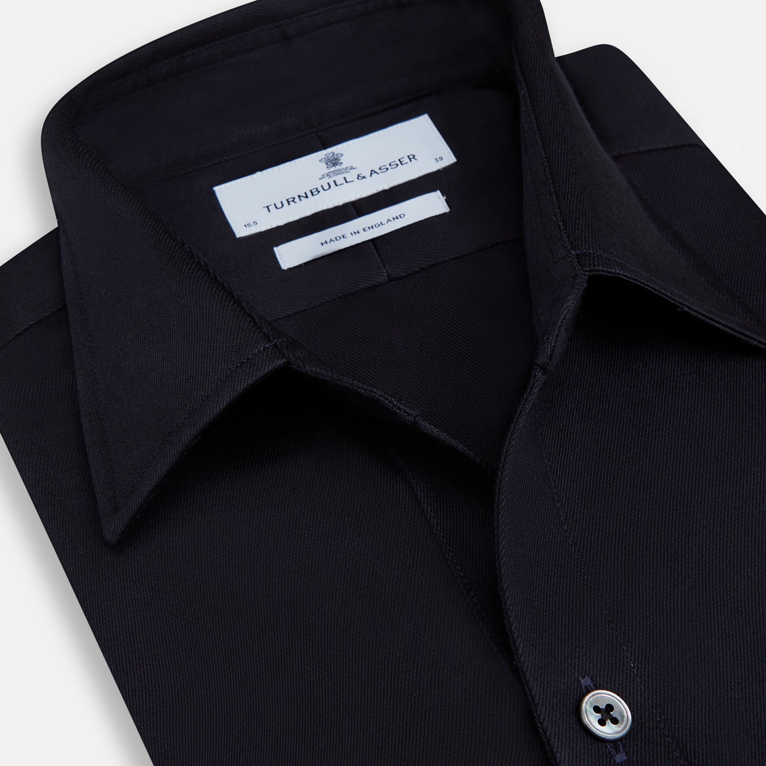 View 2 of product The Turnbull & Asser Navy Twill Chelsea Shirt is a long-sleeve button-up with a collar, front chest pocket, and white buttons, shown against a plain white background.