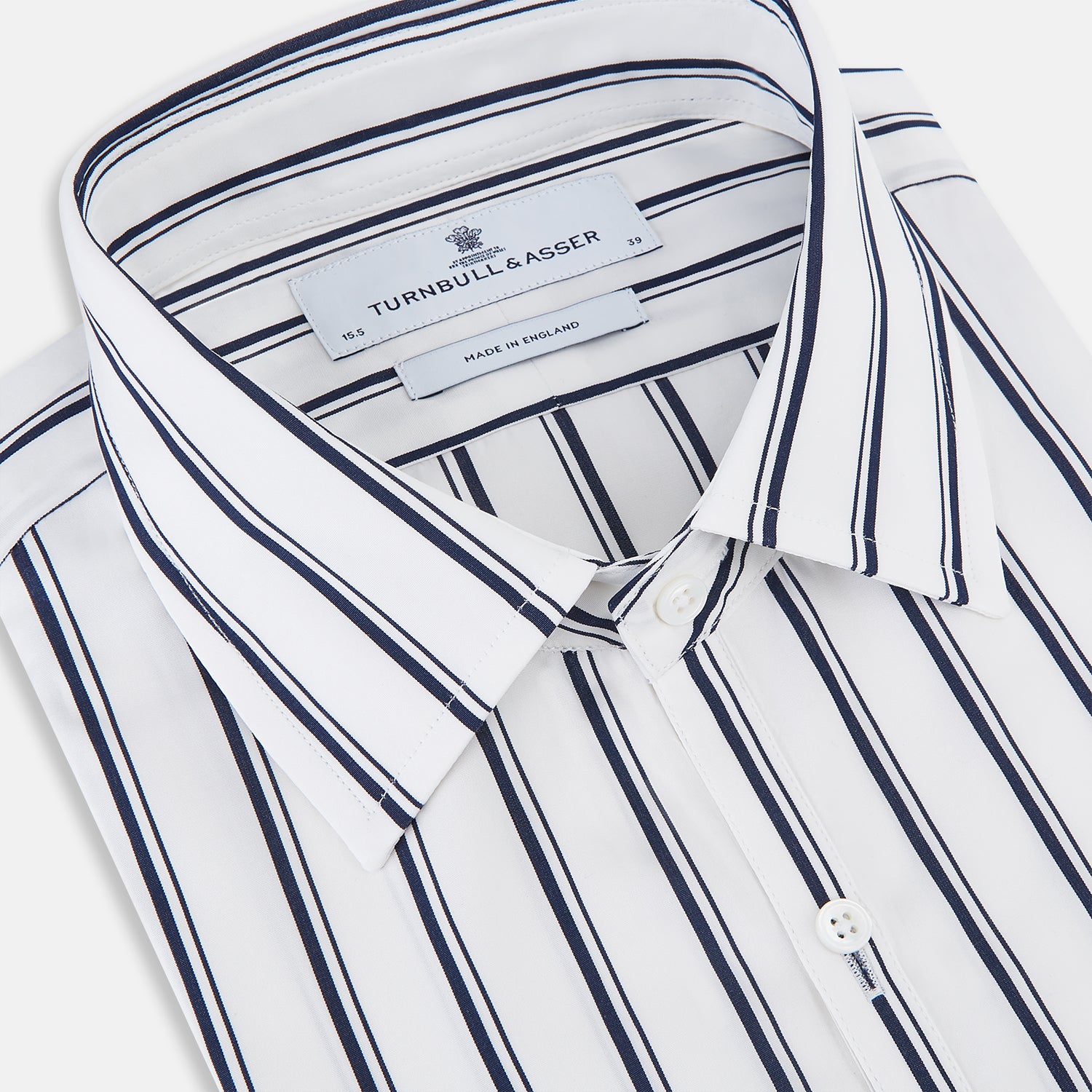 View 2 of product The Turnbull & Asser UK NAVY STRIPED COTTON WESTMINSTER SHIRT features long sleeves, a button-down front, pointed collar, and vertical navy stripes on white for classic British style.