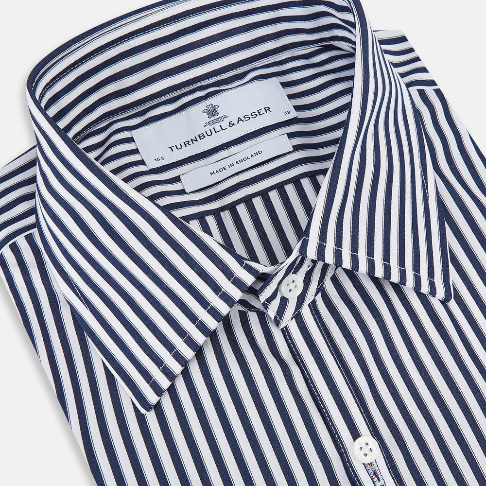 Here is a rewritten version using your product data: A Striped Navy on White Westminster Regular Fit Shirt in Cotton by Turnbull & Asser UK, featuring long sleeves, a button-up front, and a collared neckline with classic vertical stripes. The shirt is neatly laid flat on a white background.