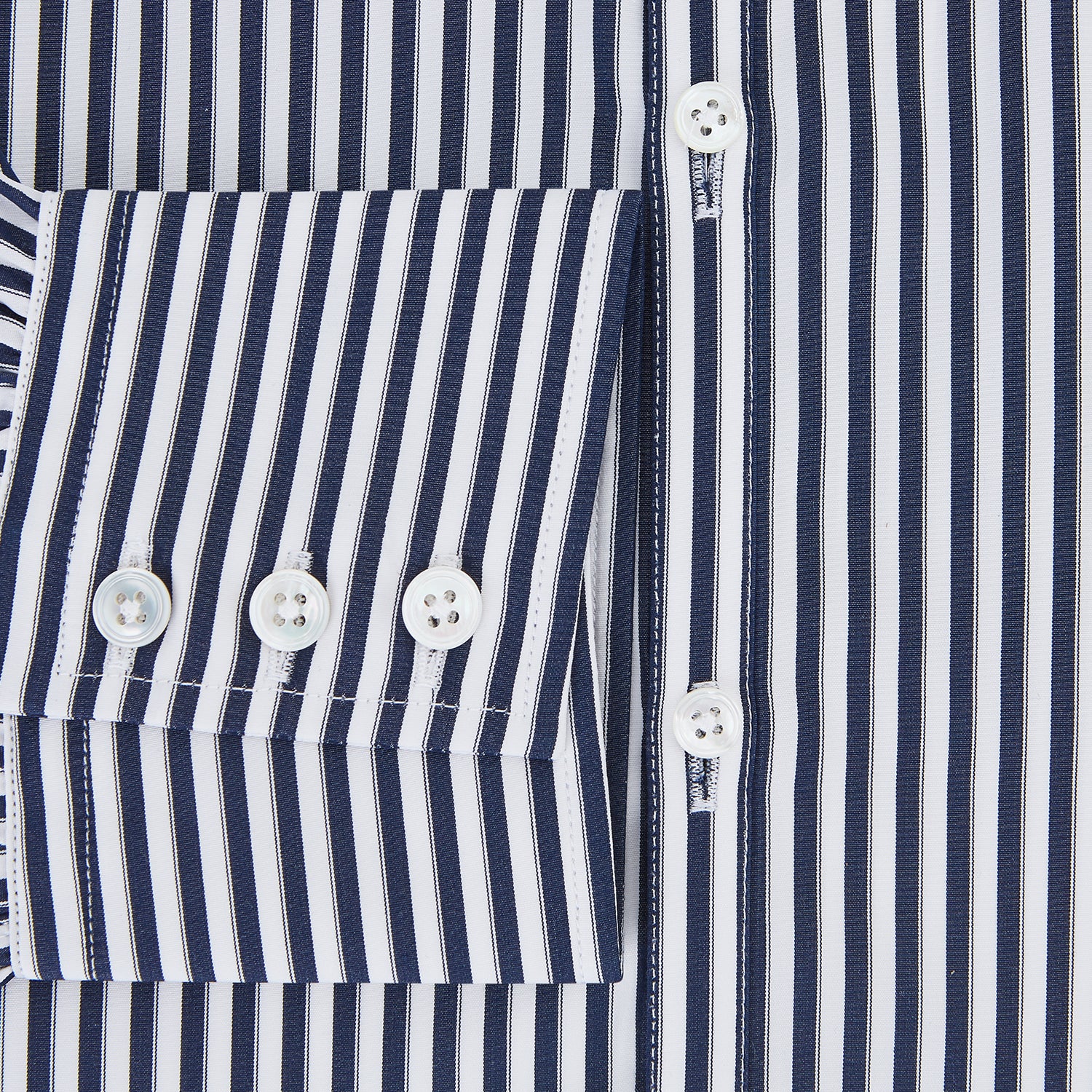 View 4 of product Here is a rewritten version using your product data: A Striped Navy on White Westminster Regular Fit Shirt in Cotton by Turnbull & Asser UK, featuring long sleeves, a button-up front, and a collared neckline with classic vertical stripes. The shirt is neatly laid flat on a white background.