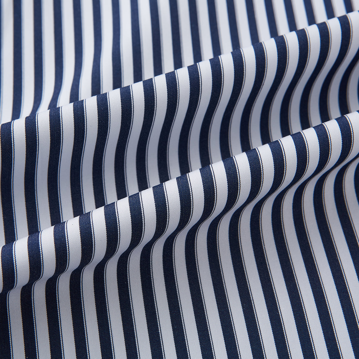 View 8 of product Here is a rewritten version using your product data: A Striped Navy on White Westminster Regular Fit Shirt in Cotton by Turnbull & Asser UK, featuring long sleeves, a button-up front, and a collared neckline with classic vertical stripes. The shirt is neatly laid flat on a white background.
