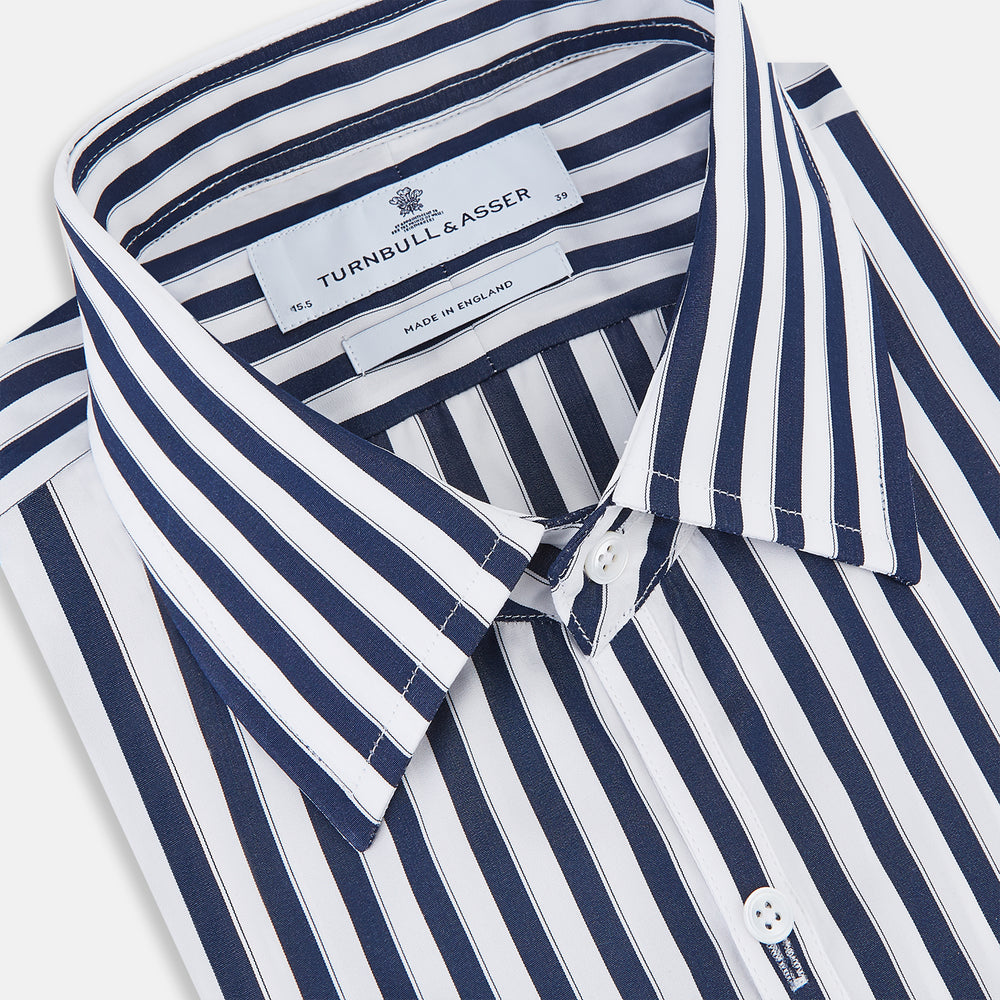 The Striped Navy on White Westminster Regular Fit Shirt in Cotton by Turnbull & Asser UK features vertical navy and white stripes, a classic collar, and buttoned cuffs—a refined example of British shirting, elegantly displayed on a white background.
