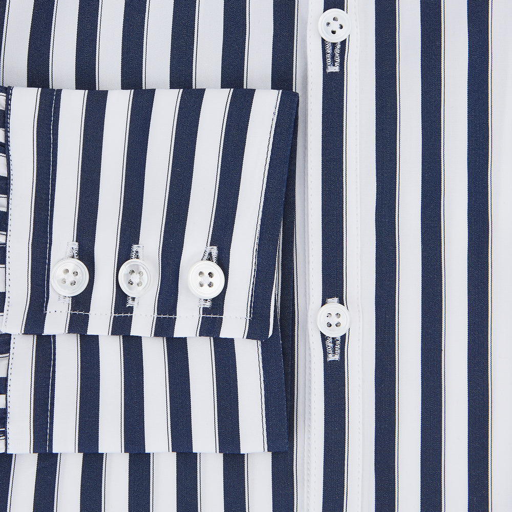 The Striped Navy on White Westminster Regular Fit Shirt in Cotton by Turnbull & Asser UK features vertical navy and white stripes, a classic collar, and buttoned cuffs—a refined example of British shirting, elegantly displayed on a white background.