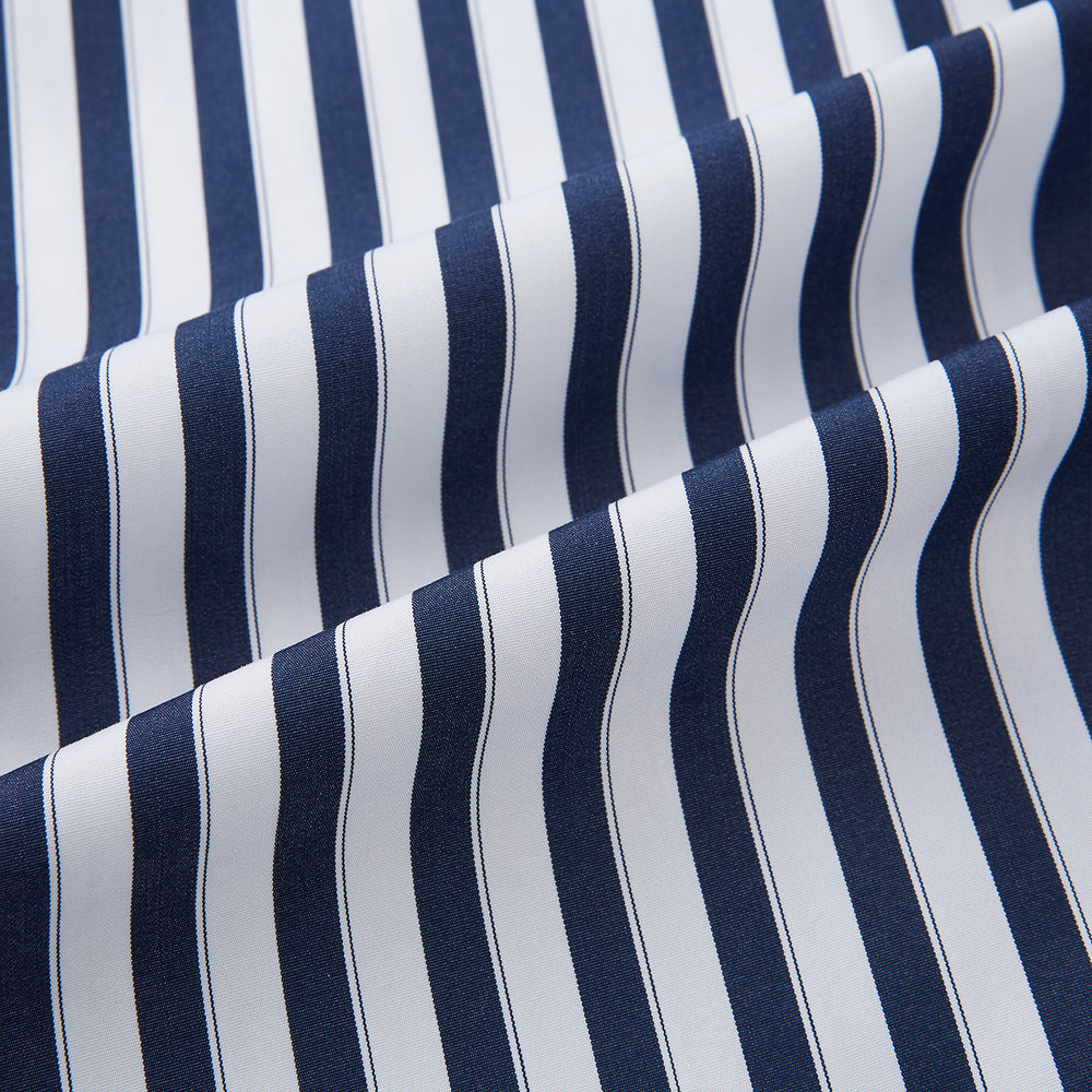The Striped Navy on White Westminster Regular Fit Shirt in Cotton by Turnbull & Asser UK features vertical navy and white stripes, a classic collar, and buttoned cuffs—a refined example of British shirting, elegantly displayed on a white background.