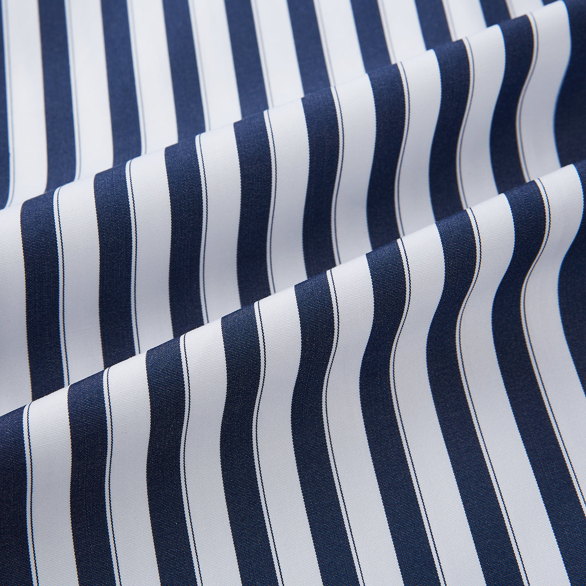 View 7 of product The Striped Navy on White Westminster Regular Fit Shirt in Cotton by Turnbull & Asser UK features vertical navy and white stripes, a classic collar, and buttoned cuffs—a refined example of British shirting, elegantly displayed on a white background.