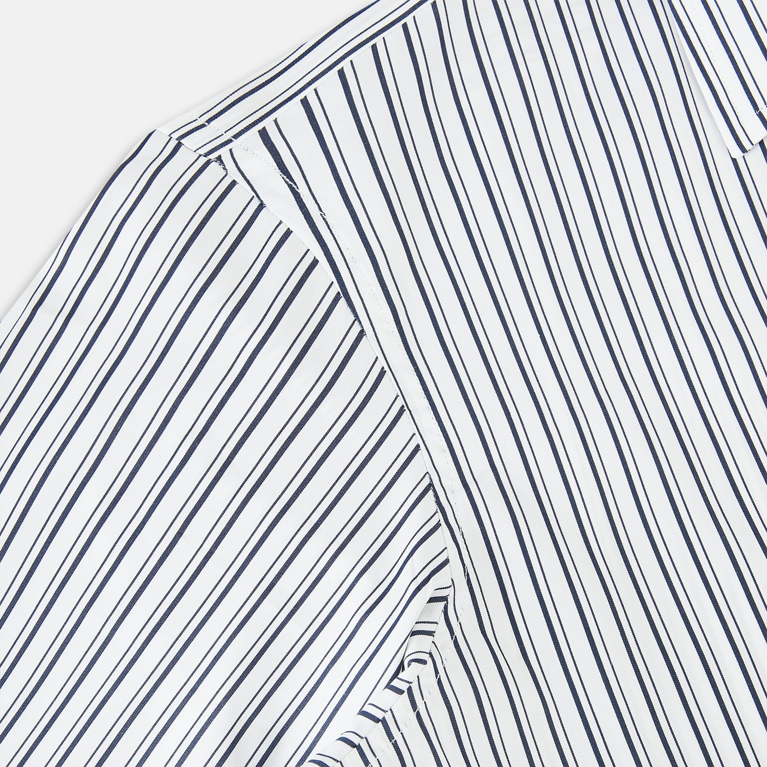 View 6 of product Turnbull & Asser UK Navy Stripe on White Westminster Shirt with a closed collar and button cuffs, laid flat on a white background.