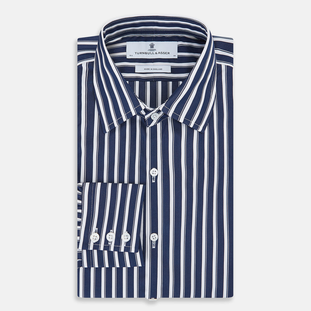 The Turnbull & Asser UK Striped Navy on White Westminster Regular Fit Shirt in Cotton features vertical navy stripes against a white background, with a classic button-up design, long sleeves, and a collar, laid flat on a white surface.