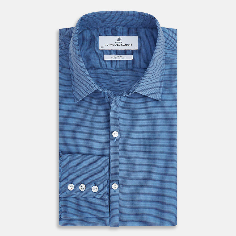 A Colony Blue Pin Check Windsor Shirt by Turnbull & Asser UK, featuring long sleeves, white buttons, a classic Turnbull collar, and buttoned cuffs—expertly crafted in Britain and displayed flat on a white background.